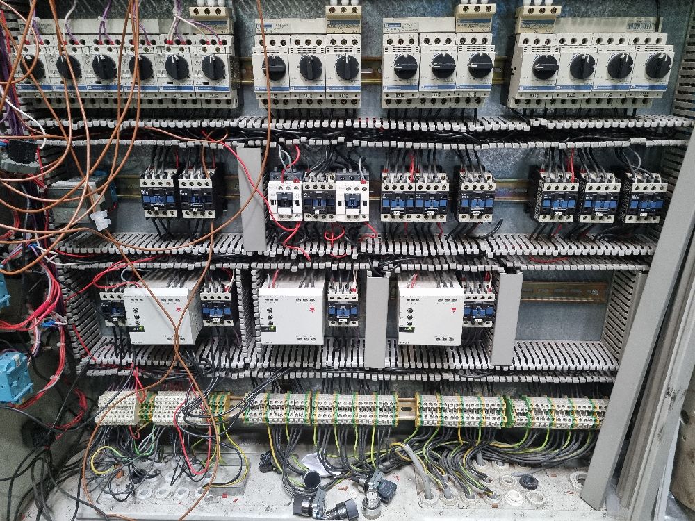 Photo of a control panel looking a mess with wires everywhere